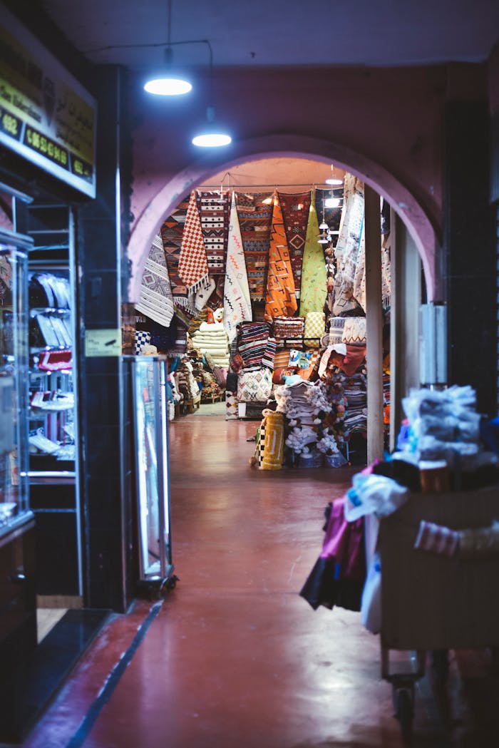 Vibrant Moroccan market scene displaying stacks of colorful textiles and rugs.